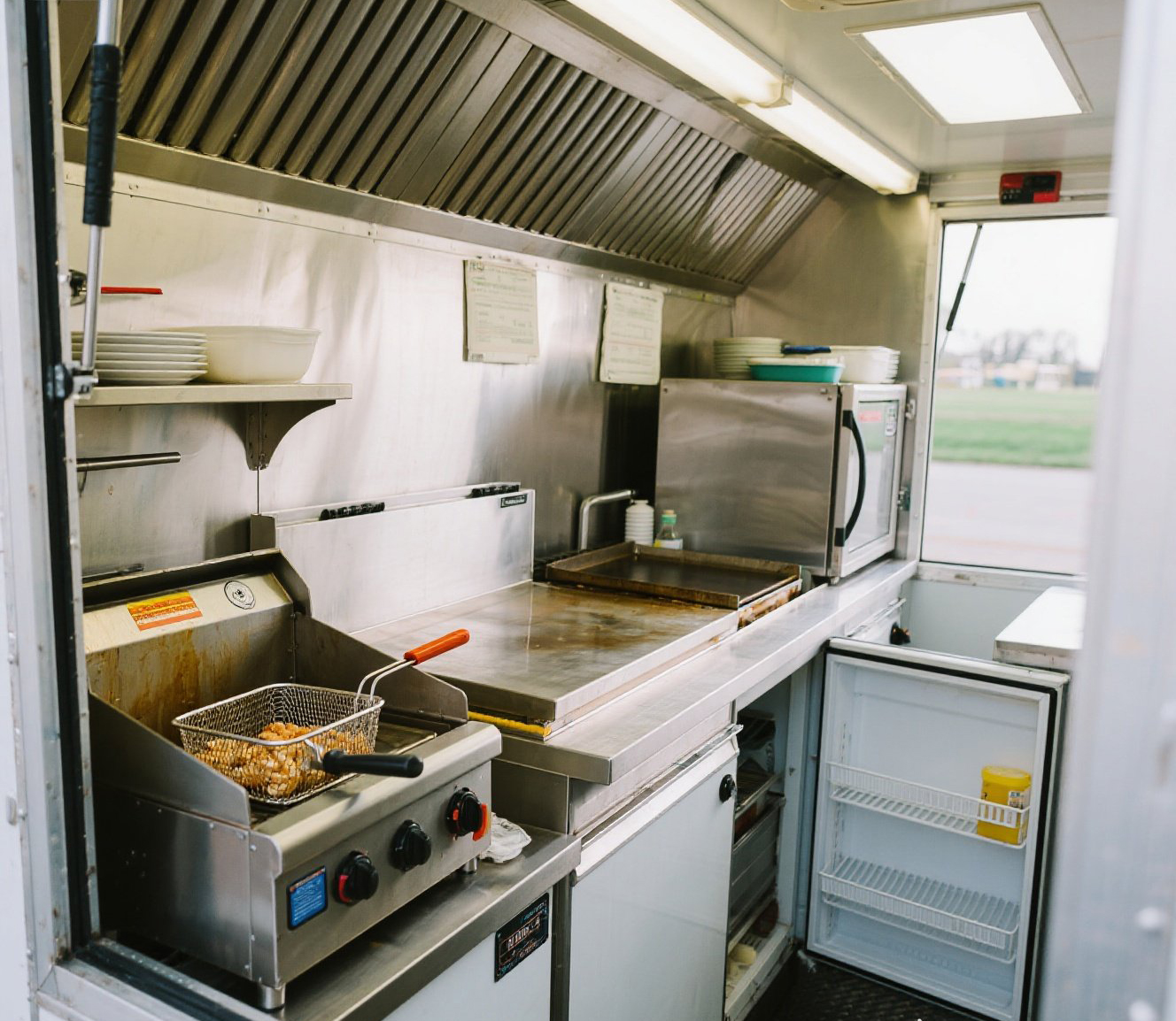 jimeng-2025-07-25-2103-Food trailer kitchen with fryer, griddle...