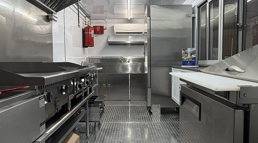 Commercial food trailer kitchen interior showing cooking refrigeration prep and wash zones